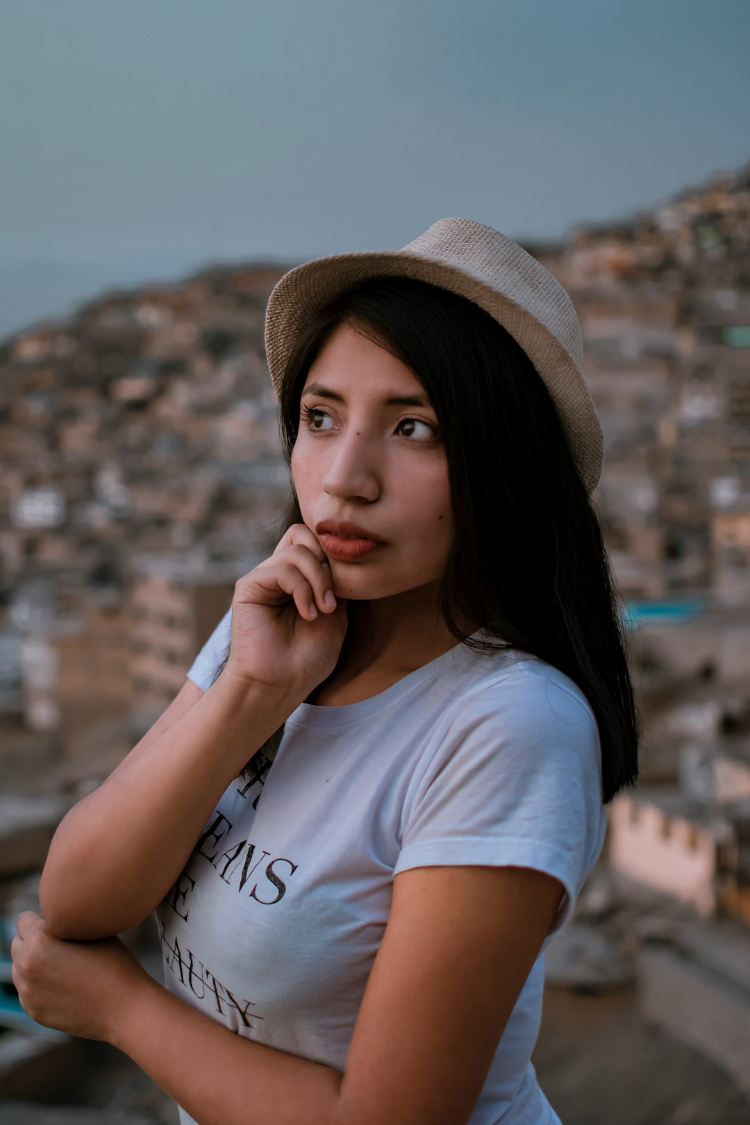 a woman in a hat is posing for a picture
