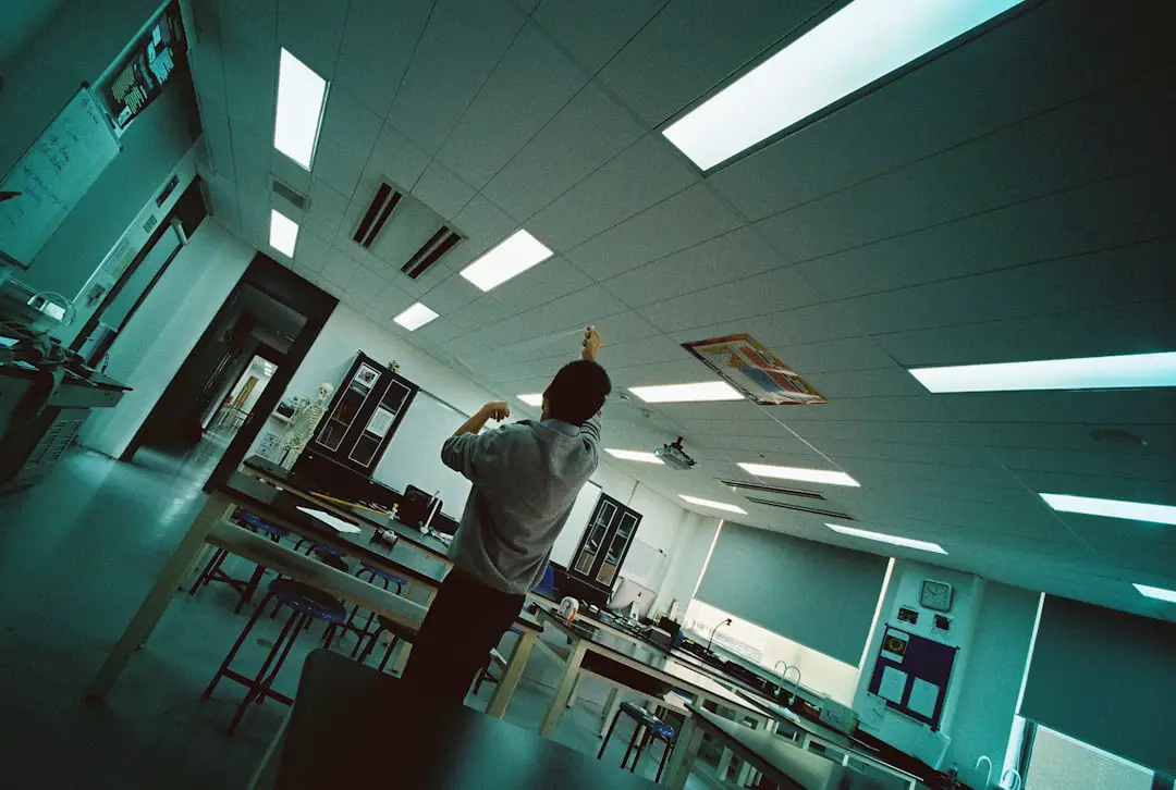 man standing while pointing on ceiling in white room