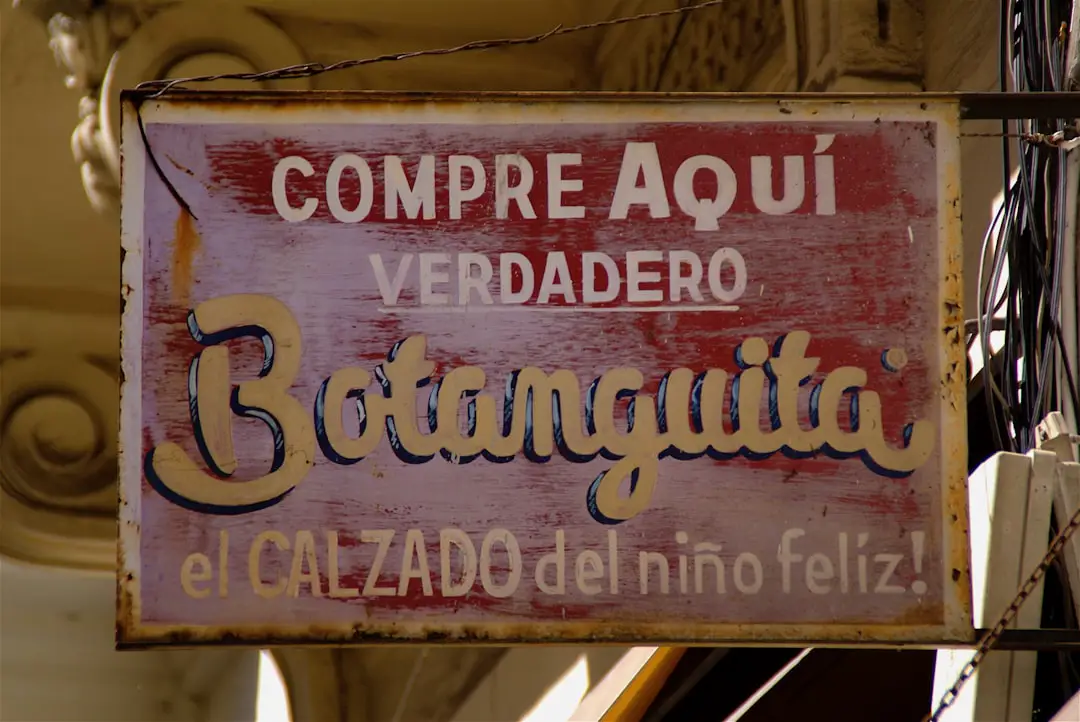 brown wooden signage on yellow textile